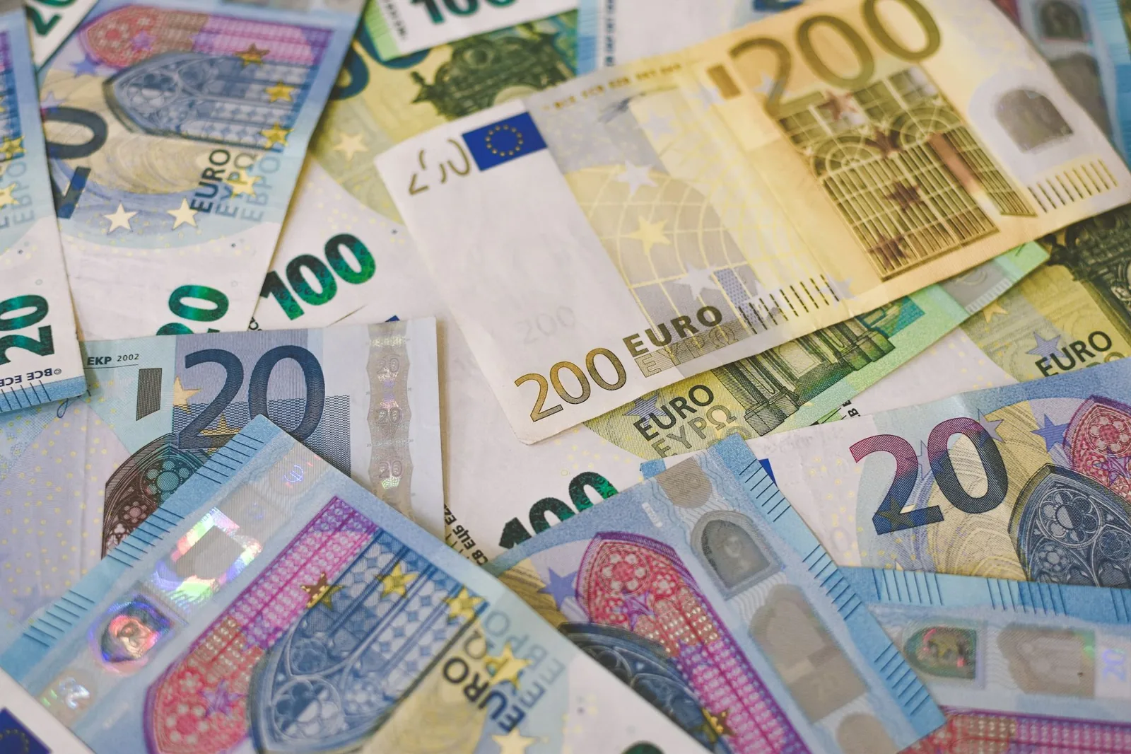 A scattered pile of euro banknotes in different denominations