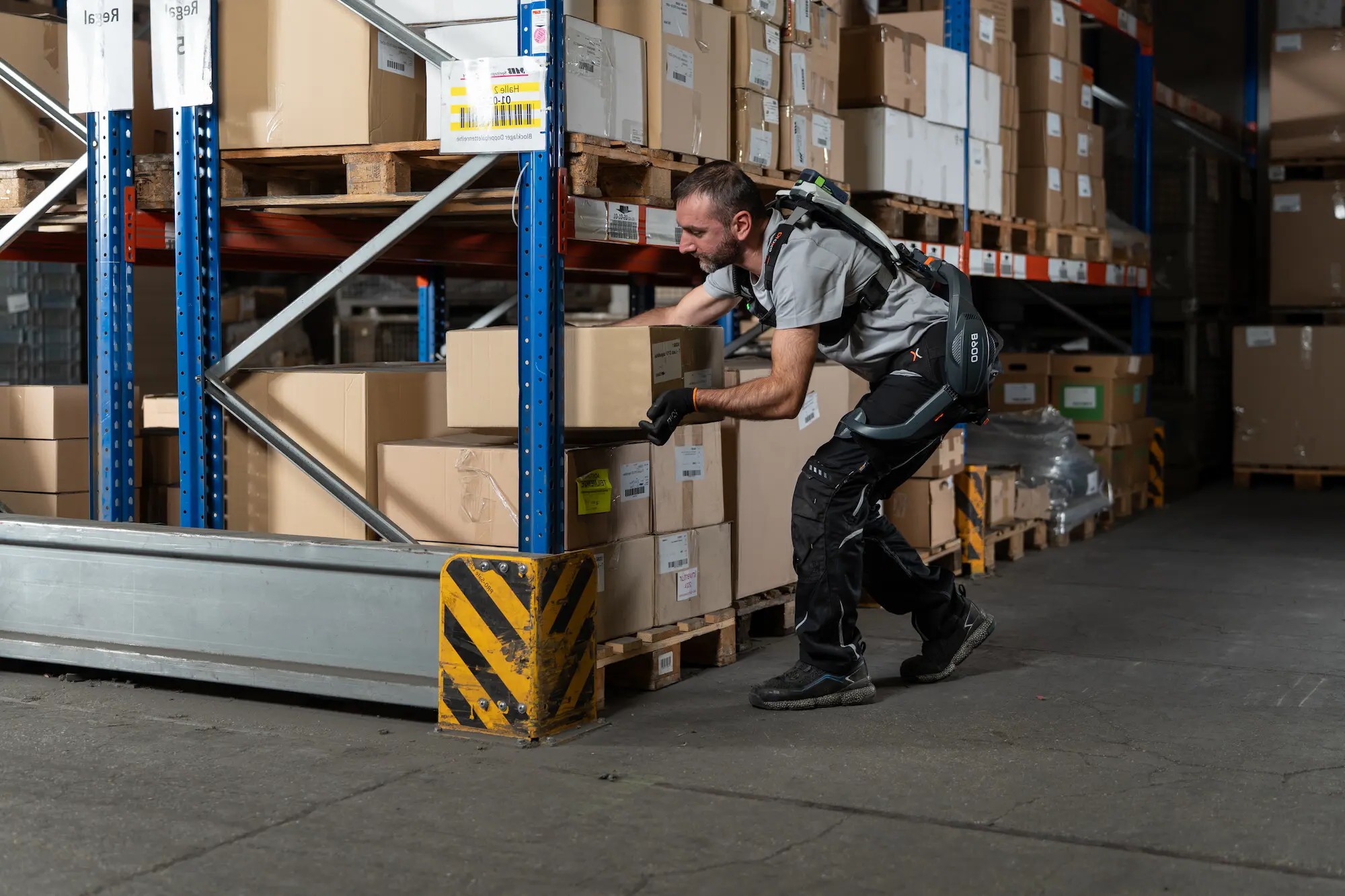 Worker with exoIQ B900 exoskeleton
