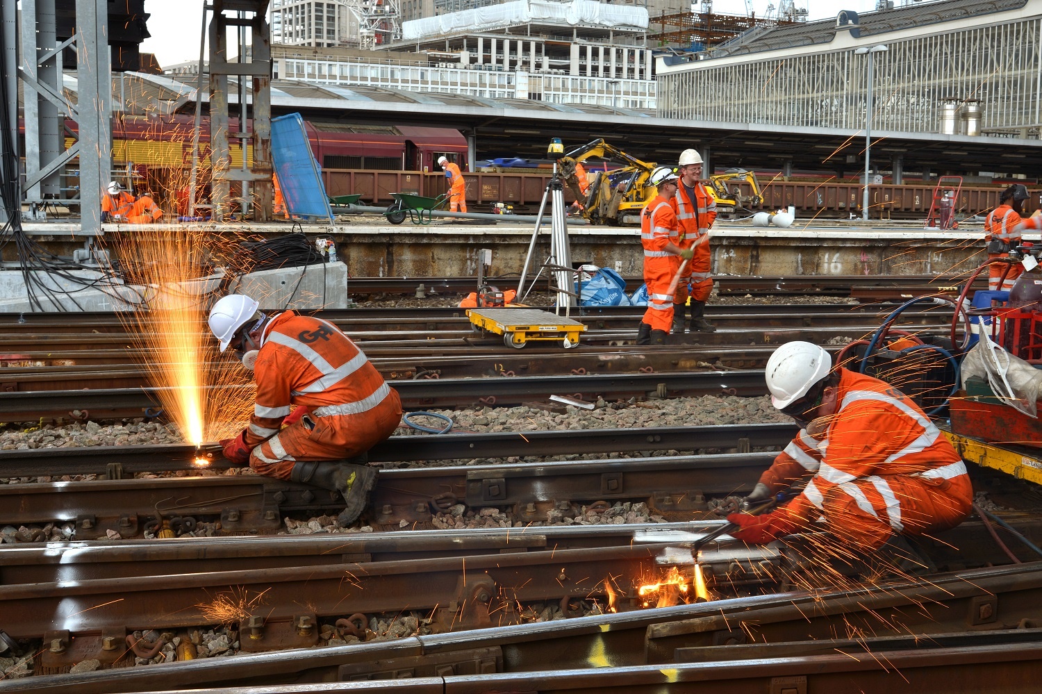 Railway maintenance worker wearing exoskeleton
