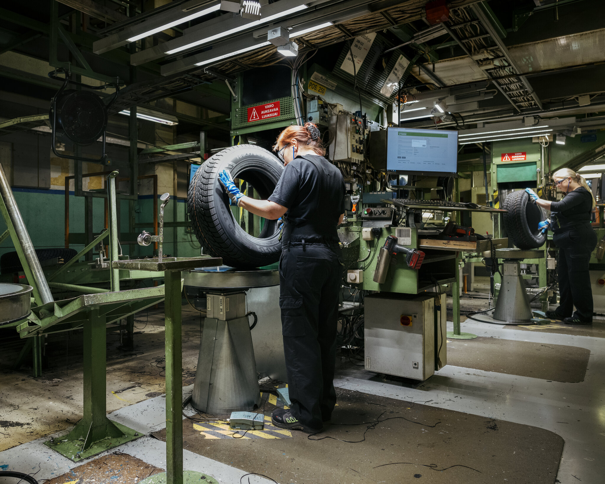 Tire factory worker wearing exoskeleton